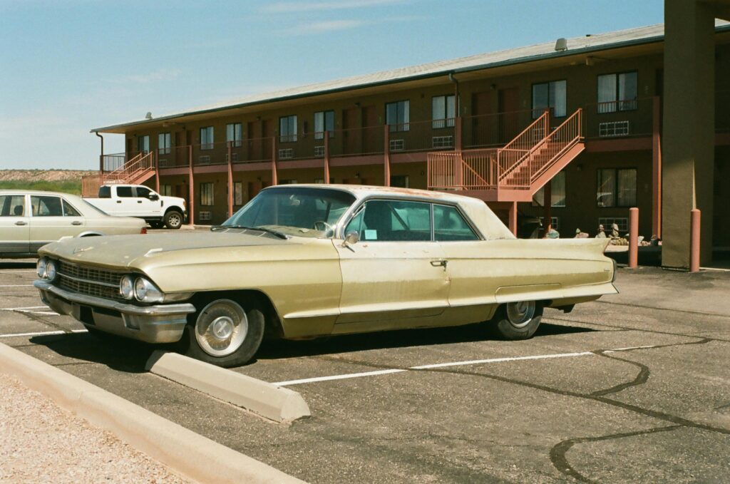 Image Shows a Motel With car in parking
